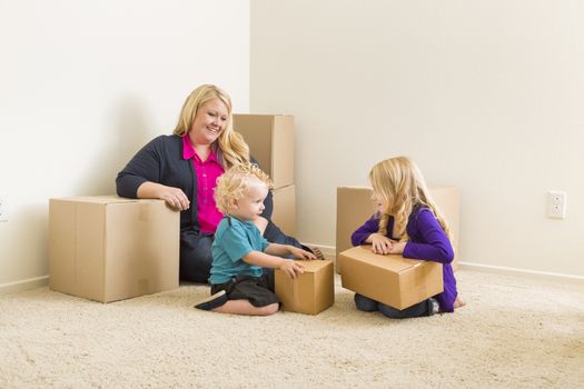 Happy Young Family in Empty Room With Moving Boxes.