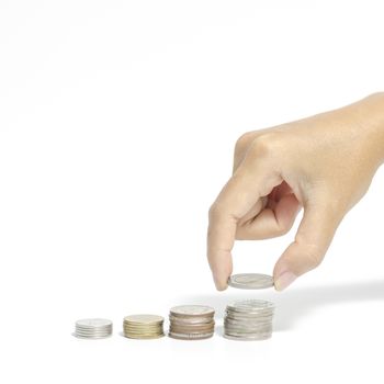 woman hand putting stack of coins on a white background