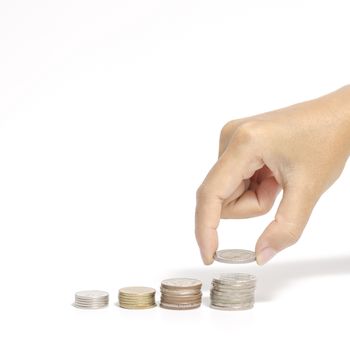 woman hand putting stack of coins on a white background