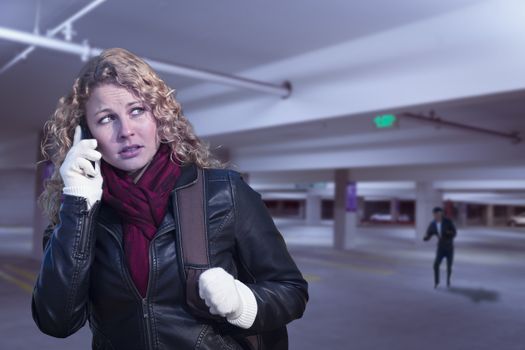 Frightened Young Woman On Cell Phone As Dark Man Lurks in Parking Structure.