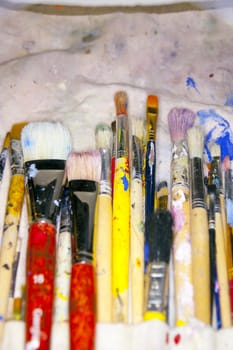 collection of various artists brushes in all sizes on a canvas background