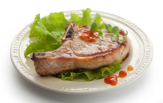 Fried pork cutlet with fresh green lettuce on the plate