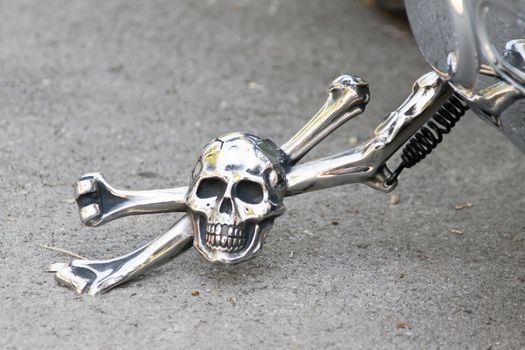 shiny prop-stand of motor bike, skull and bones prop-stand