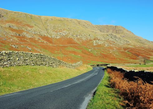 An image of a quiet country road in the English Lake District.