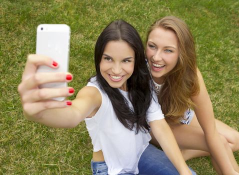 Beautiful and happy teenagers taking selfies