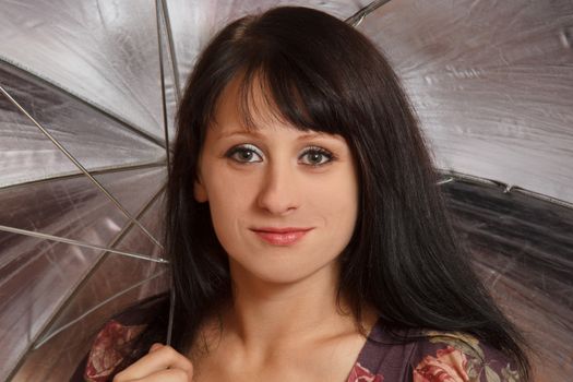 smiling young woman with a gray umbrella