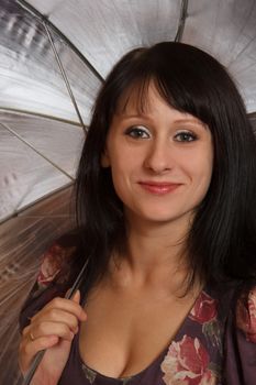smiling young woman with a gray umbrella