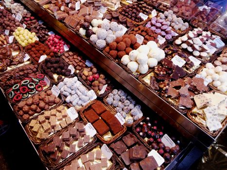 Different kinds of chocolate in open market Boceria, Spain, Barcelona