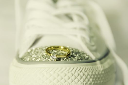 Closeup of ngagement ring on top of rubber shoe