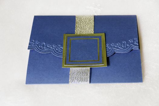 Royal blue invitation shot against bride's white veil