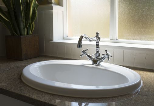 Old retro water tap basin in modern bathroom toilet with window