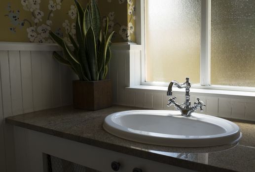 Old retro water tap basin in modern bathroom toilet with window