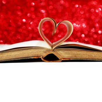 Heart shaped book pages on glitter background