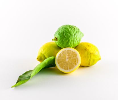 Fresh lemons yellow and green on white background