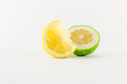 Slice of fresh lemon yellow on white background