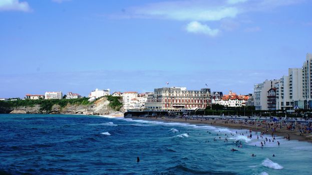 Public beach with many people in Biarritz, France