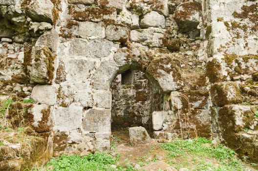 Fragment of the old fortress wall with the entrance to the tower