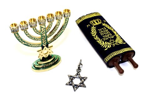 Torah with Star of David and menorah on a light background