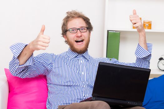 Man has joy at the computer on his knee