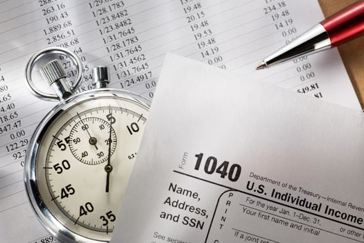 Tax form, operating budget and stopwatch