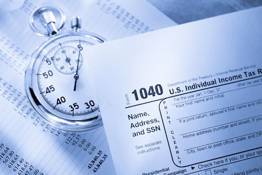 Tax form, operating budget and stopwatch