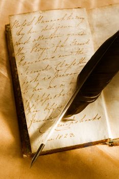 Old book with feather pen