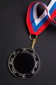 Metal medal with tricolor ribbon 