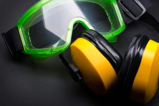 Green goggles with earphones on black