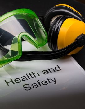 Health and safety register with goggles and earphones 