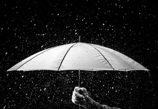 Umbrella under raindrops in black and white