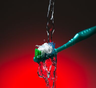 Toothbrush under stream of water 