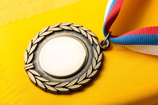 Metal medal with tricolor ribbon