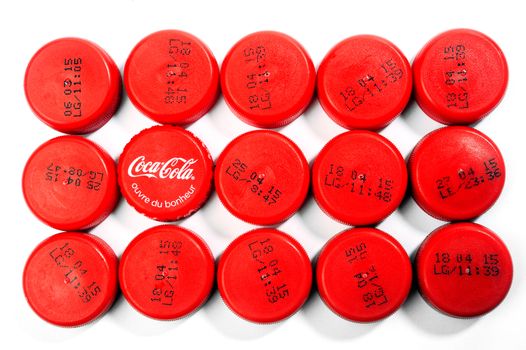 A set of plastic caps from soda bottles and unbranded cola in the middle