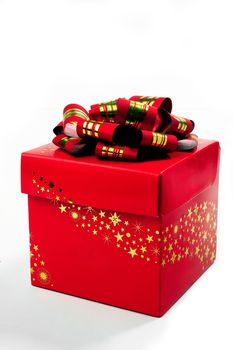 A red gift box with a red bow and gold