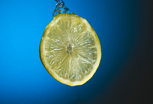Slice of lemon in water splash 