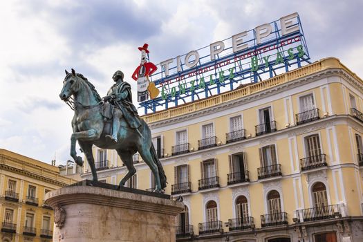 King Carlos III Equestrian Statue Famous Tio Pepe Sign Puerta del Sol Gate of the Sun Most Famous Square in Madrid Spain King of Spain in the 1700s.  Replica of statue created in 1700s by Juan Pascal de de Mena