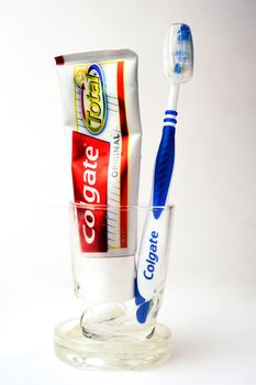 Set of Colgate toothpaste with toothbrush on white background