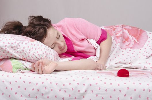 The girl lying in bed gave a ring in the case
