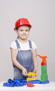 Girl playing in the Builder builds from the designer house.