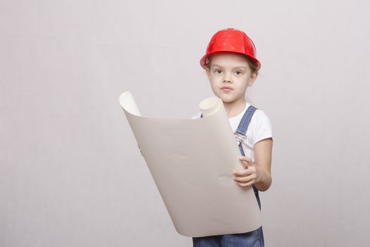 Girl playing Builder launched the drawing up and looks into the drawing