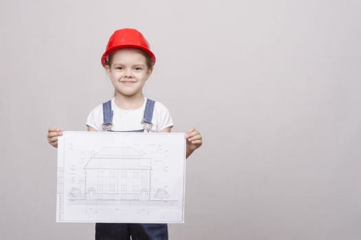 The girl in the helmet smiles and standing with a white sheet