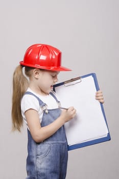 Girl engineer is a helmet folder and pencil