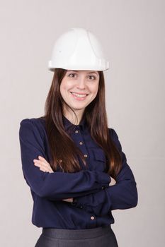Portrait of a young beautiful girl engineer, architect in helmet