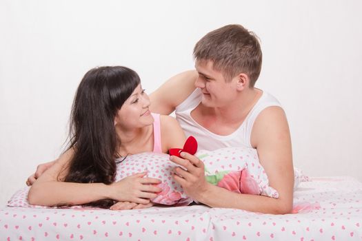Young man offers the young girl to marry him, and gives a ring