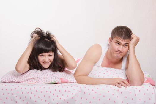 Young couple disappointed missed chance lie in bed