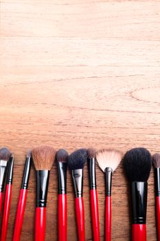 cosmetics makeup brush, on wood table background