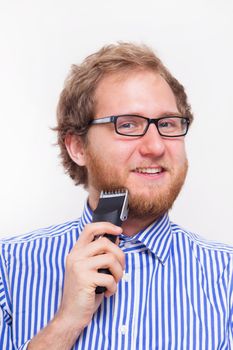 Bearded man with an electric razor - studio shoot 