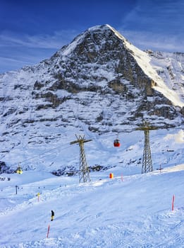 Snowboarder on the slope at winter sport resort in swiss alps