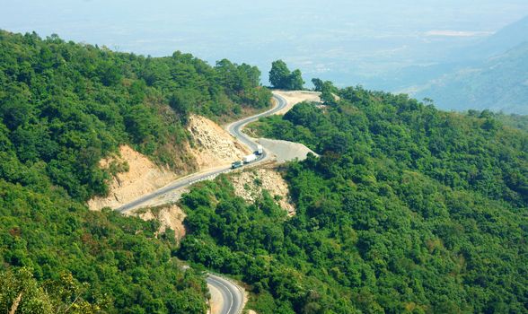 Wonderful scene of nature on day, row and row mountain, green forest, transportation on mountain pass, road connect Dalat, Phan Rang, it call Ngoan Muc mountain pass, zigzag, danger, nice for travel