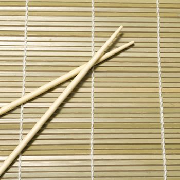 chopsticks on sushi mat